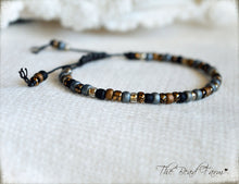 Load image into Gallery viewer, Adjustable Boho Hippie Seed Bead Bracelet in denim blue, gold, and black